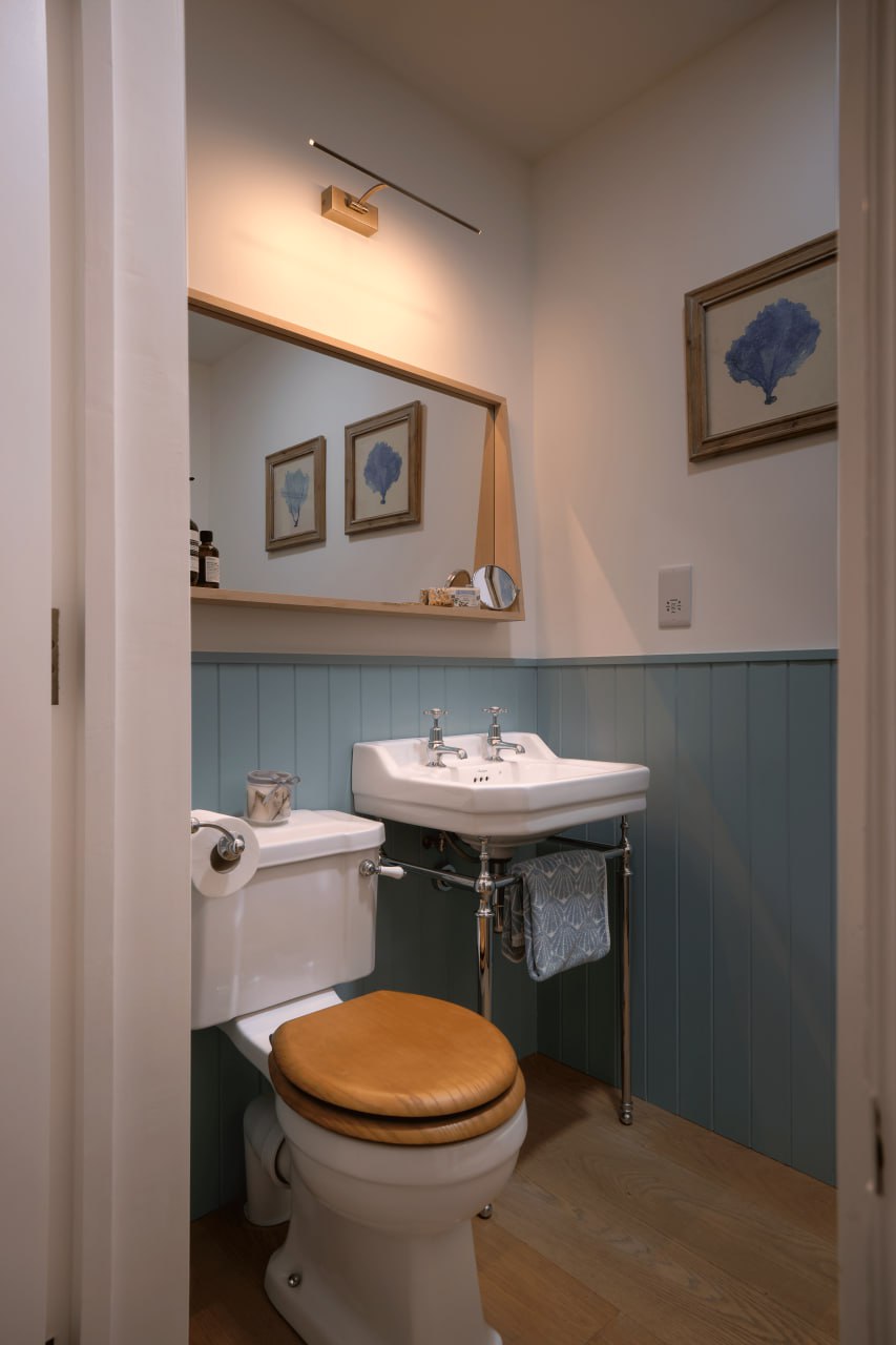The cloakroom, panelled to dado height.