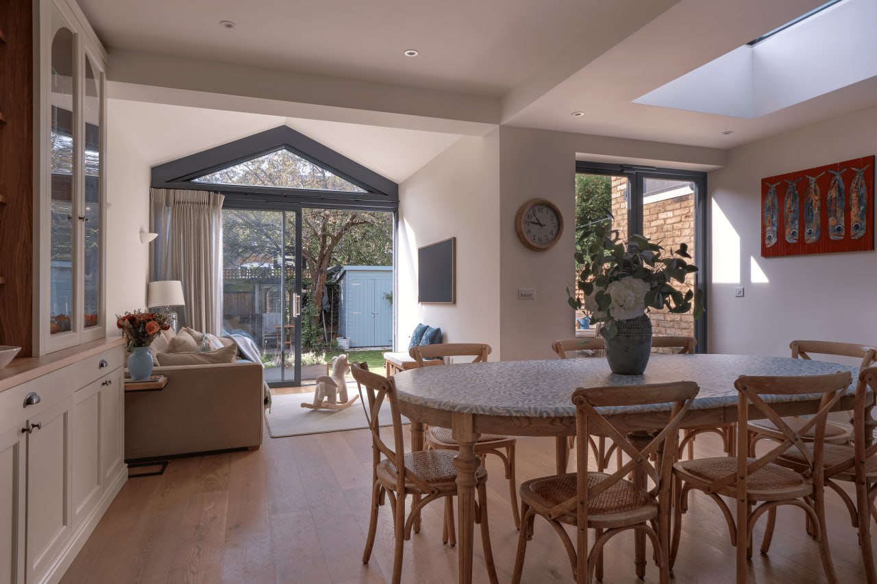 The dining table under the gable, with the garden beyond.