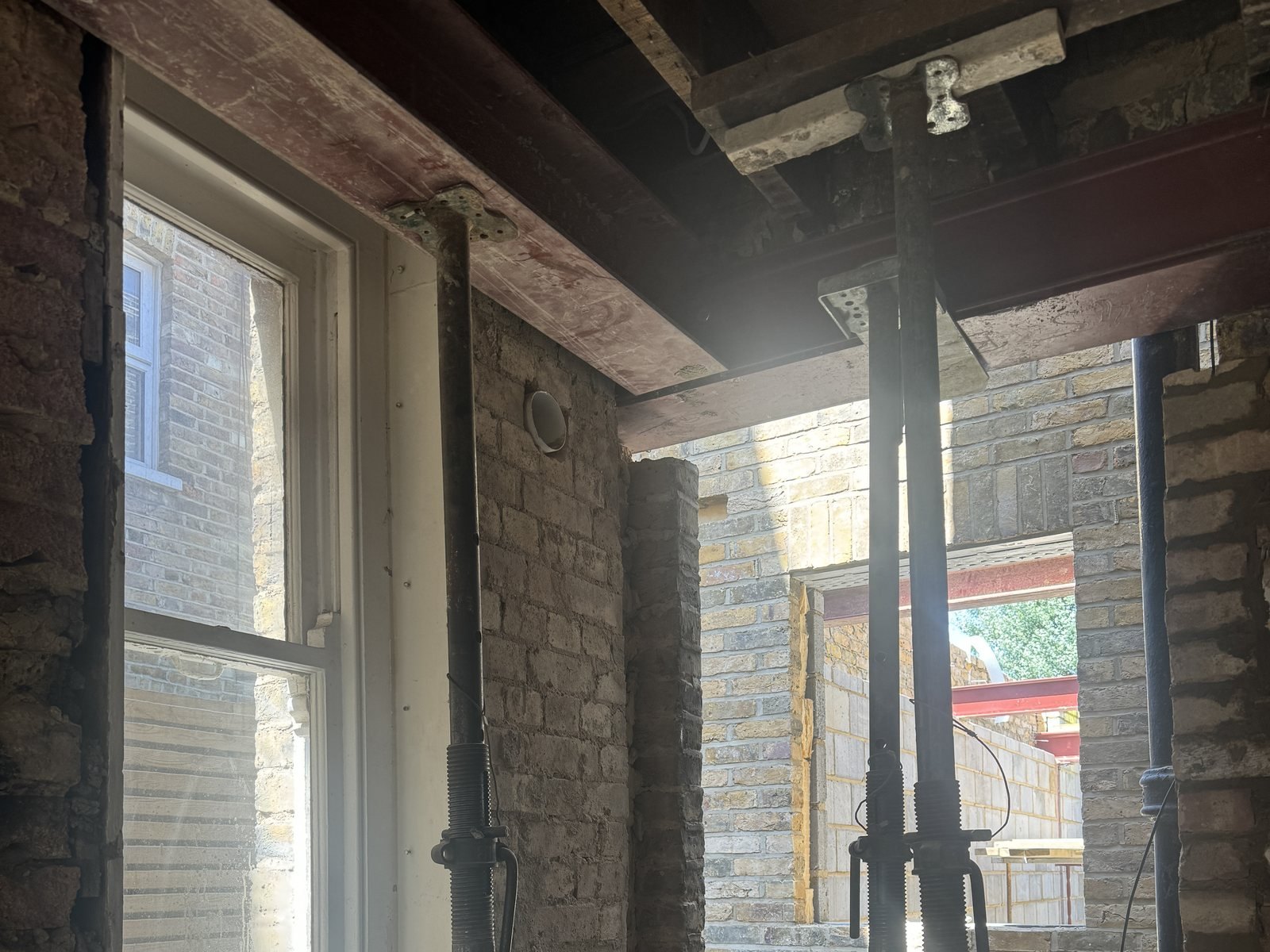 New steel going in under the old ceiling, with props holding what was above.