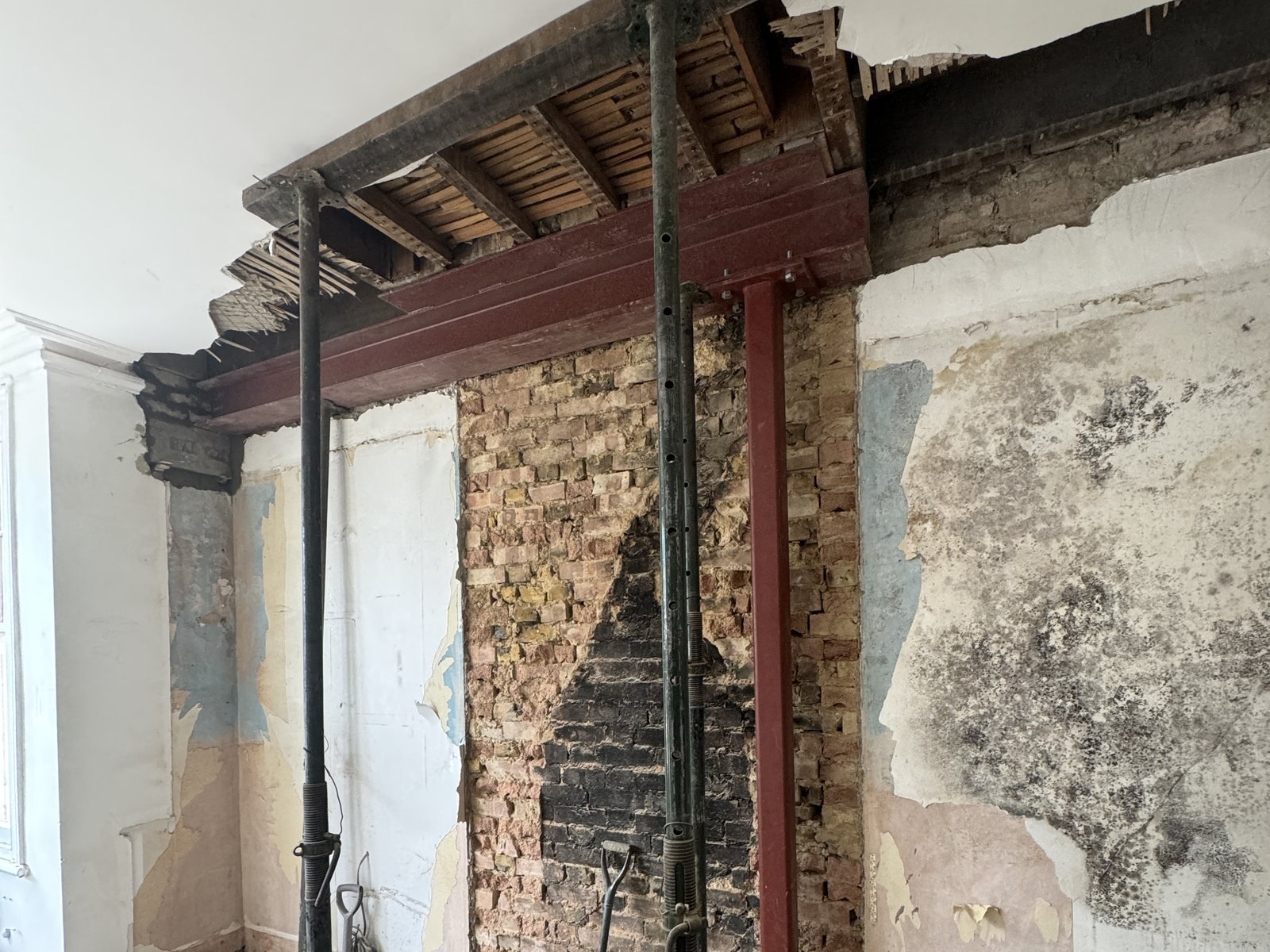 A chimney breast carried on new steel, with posts either side while the floor below was taken up.