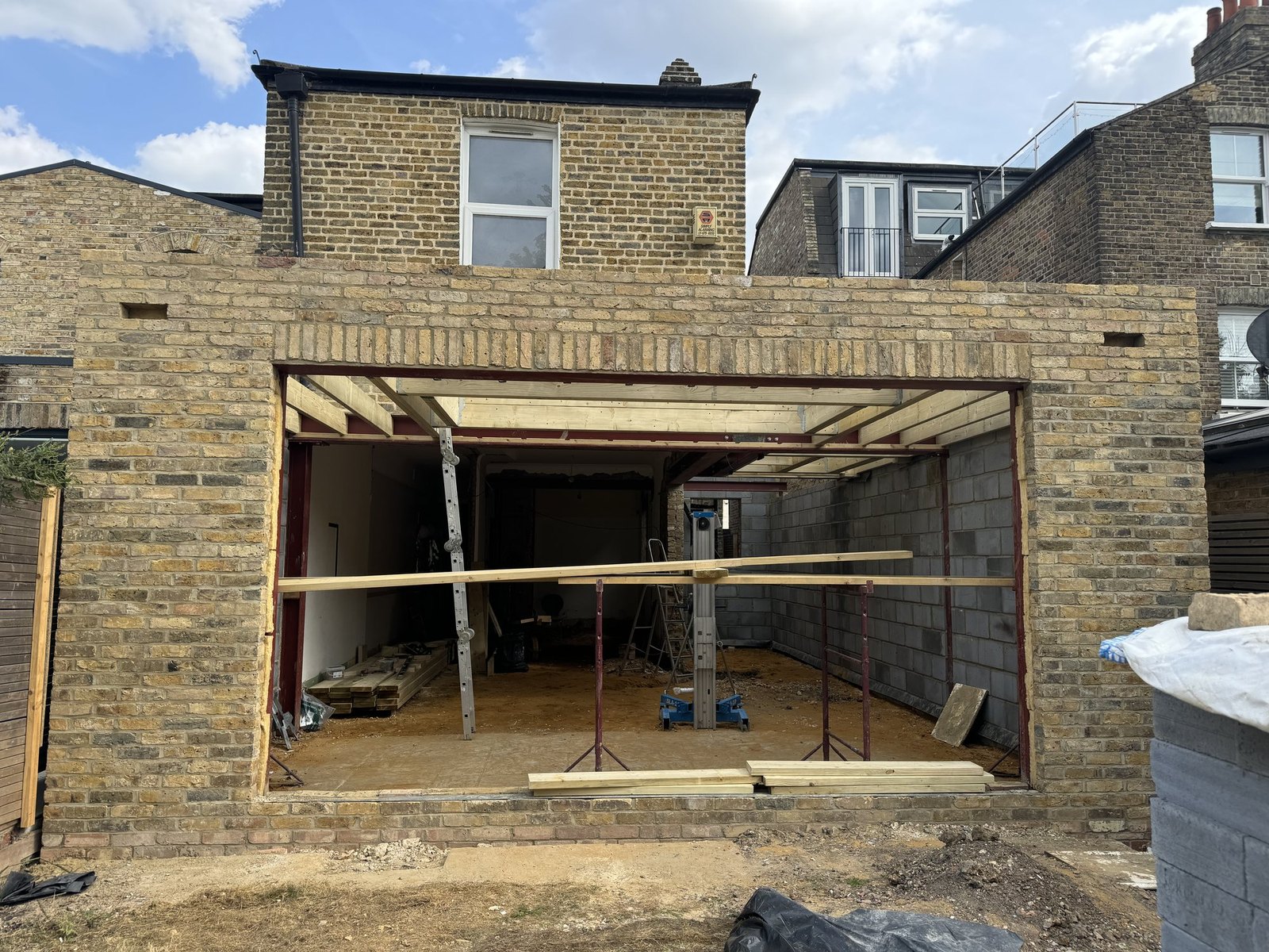 The new back wall up in blockwork and yellow London brick, with the opening for the folding doors.
