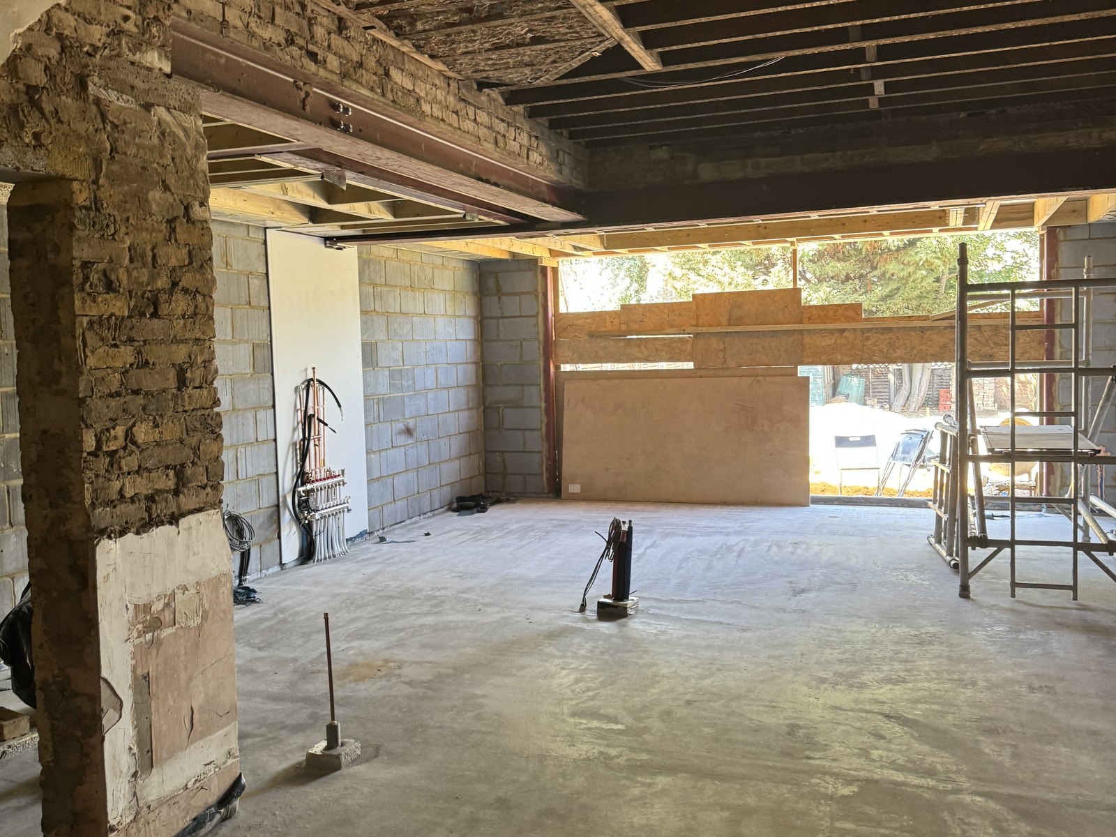 The new slab down and the steel in overhead, with the opening to the garden boarded up.