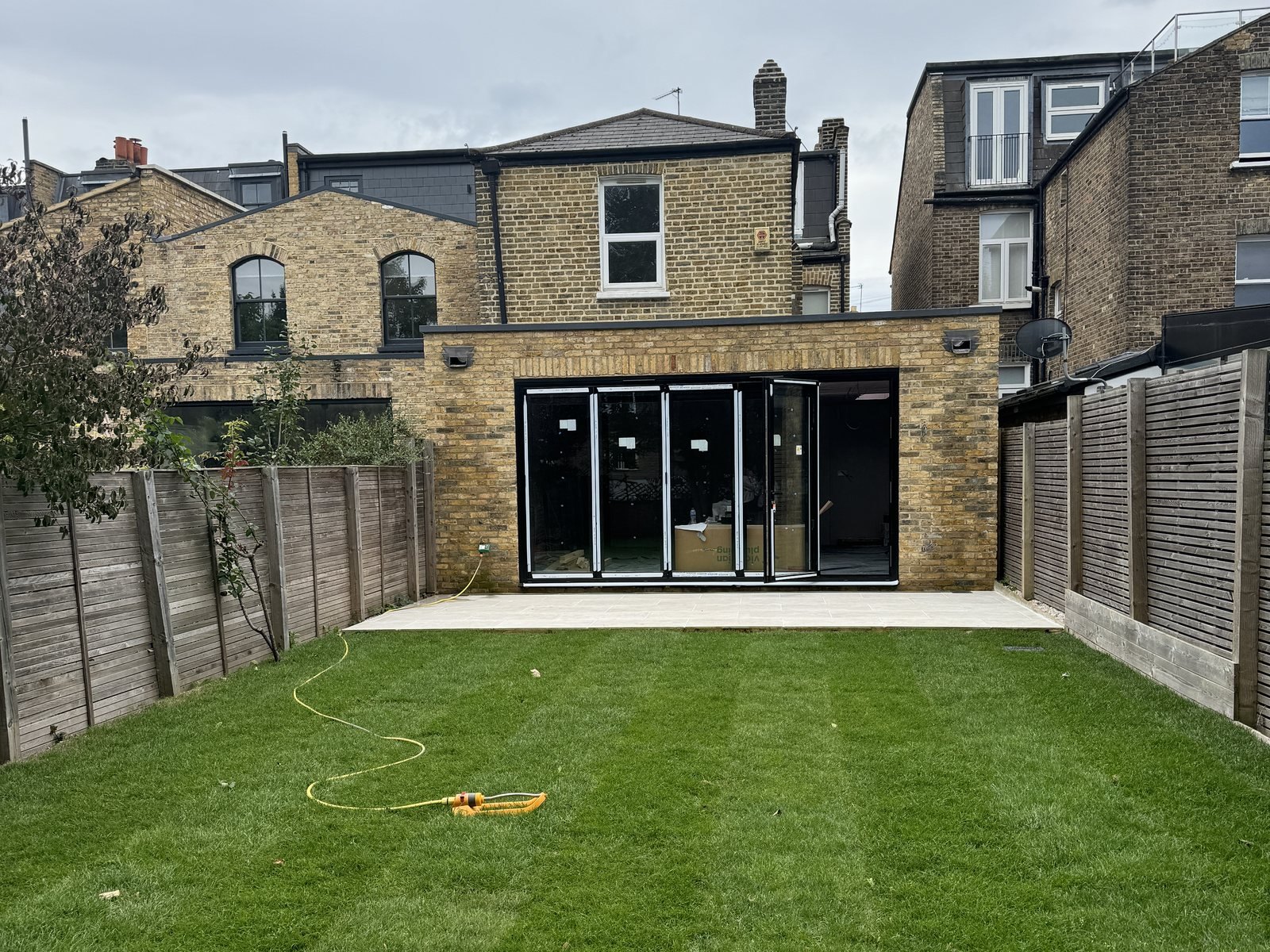 The extension from the garden, with the folding doors in and the lawn down.