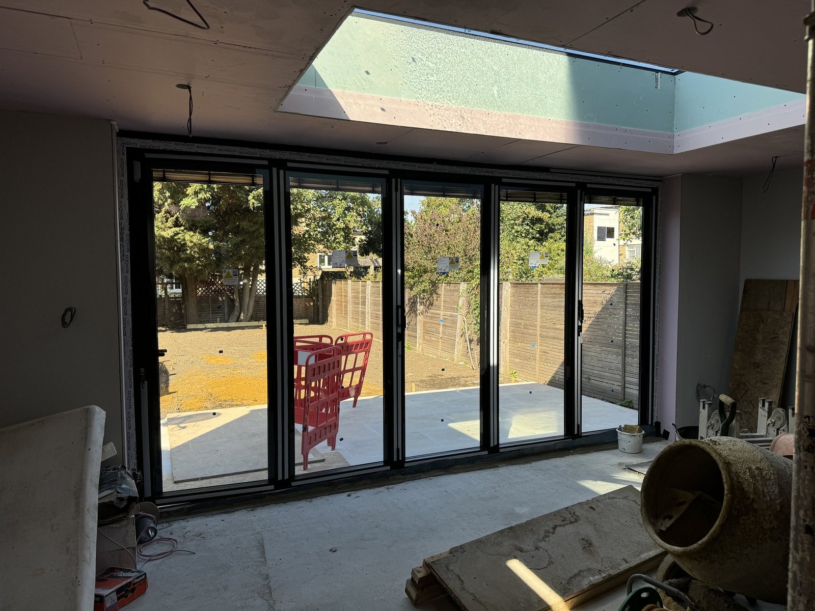 Folding doors fitted, the rooflight lined and the plasterboard up.