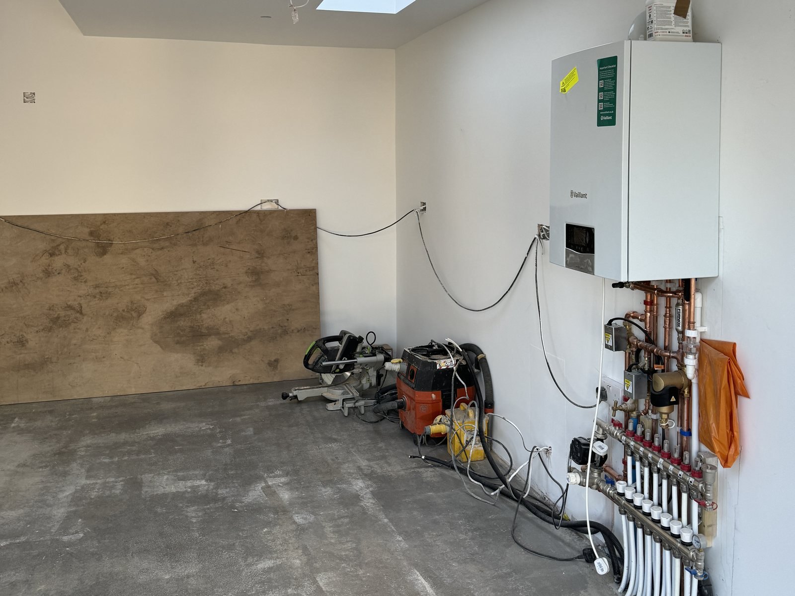 Underfloor heating pipework, with the combination boiler and manifold on the wall.