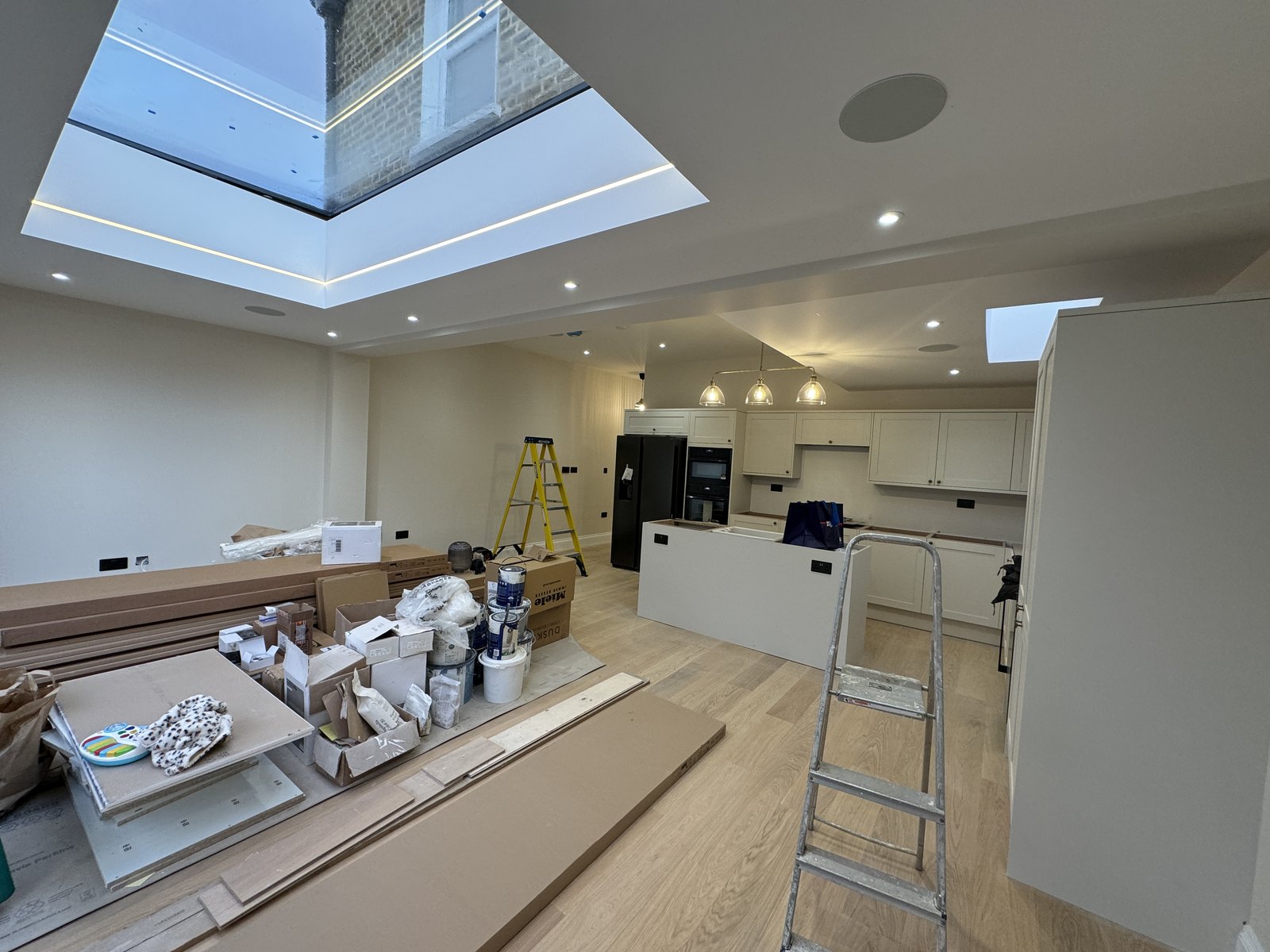 The kitchen and island going in under the lined rooflight.