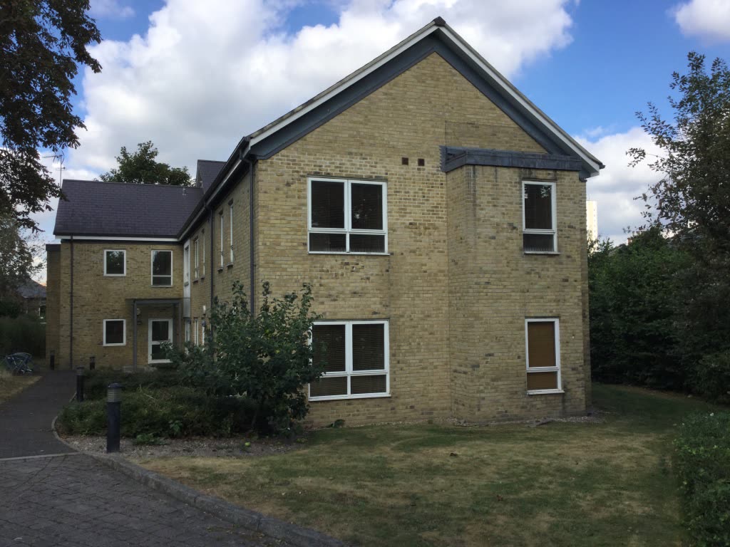Before. Two and three storeys of yellow-beige stock brick, and no land left to build on.