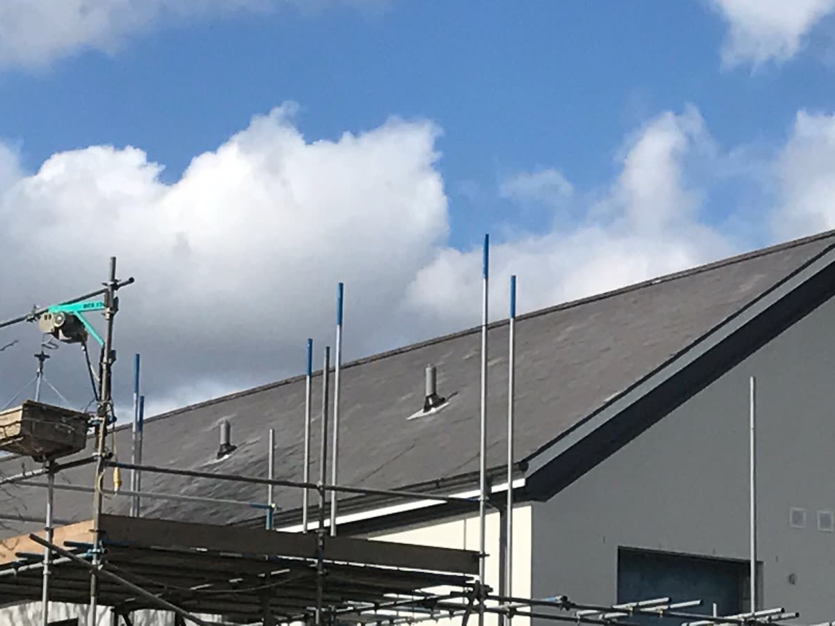 Interlocking Cambrian slate on, matched to the existing roof.