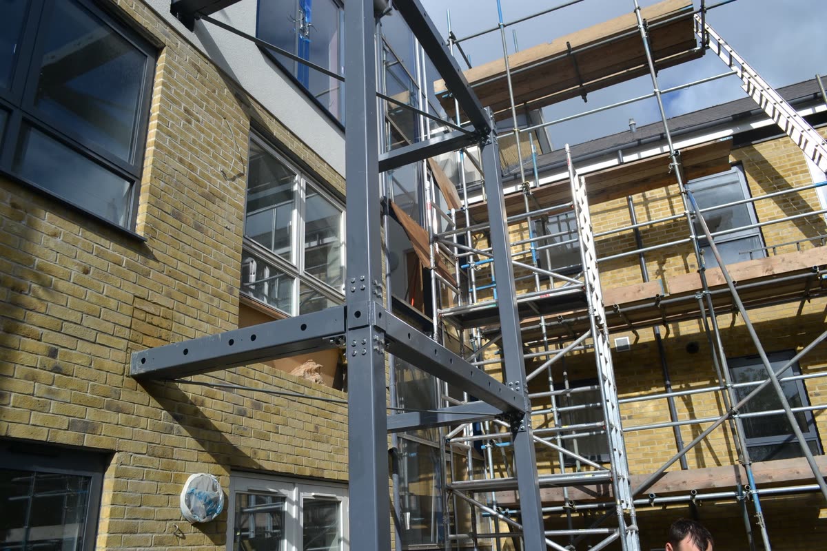 Balcony steel going into the existing elevation. Five of the eight were cut into flats that stayed occupied.