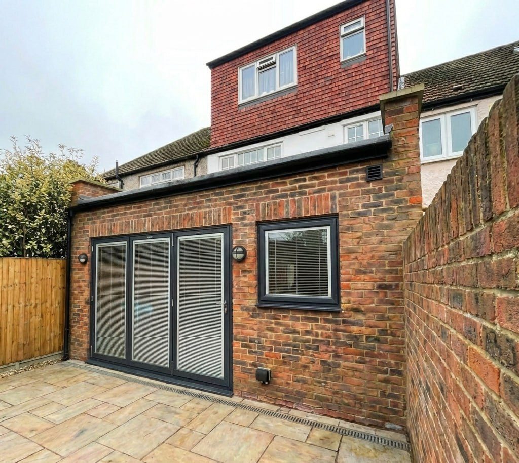 The extension from the side, with folding doors onto the new paving.